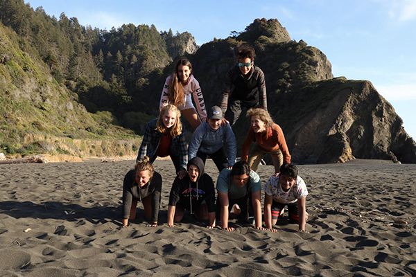 Gr 8 students make a human pyramid on the beach 
