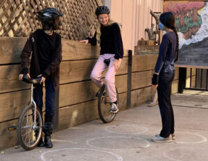 Middle school girls learn how to use a unicycle