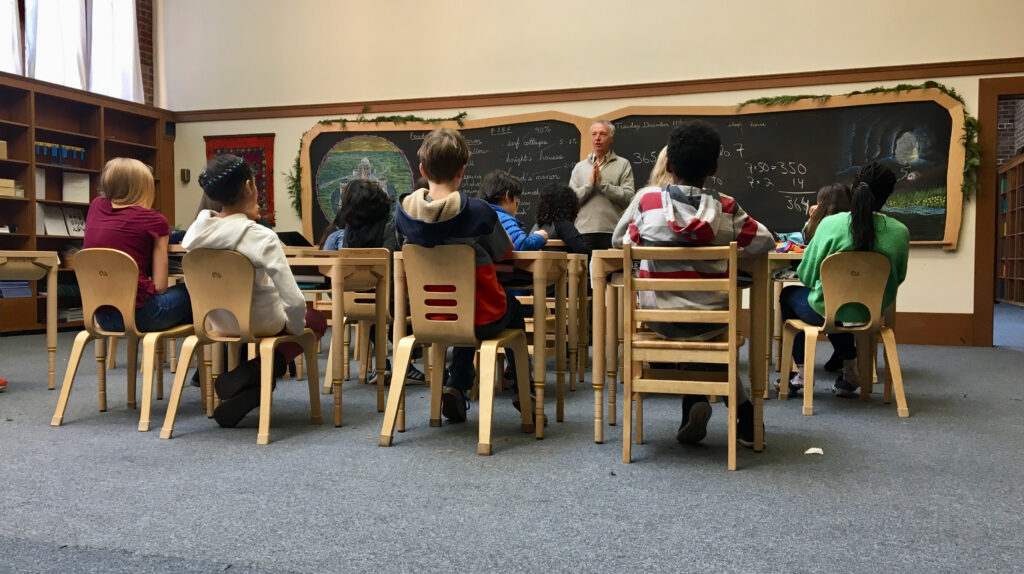 Math teacher with grade students sitting at their desks
