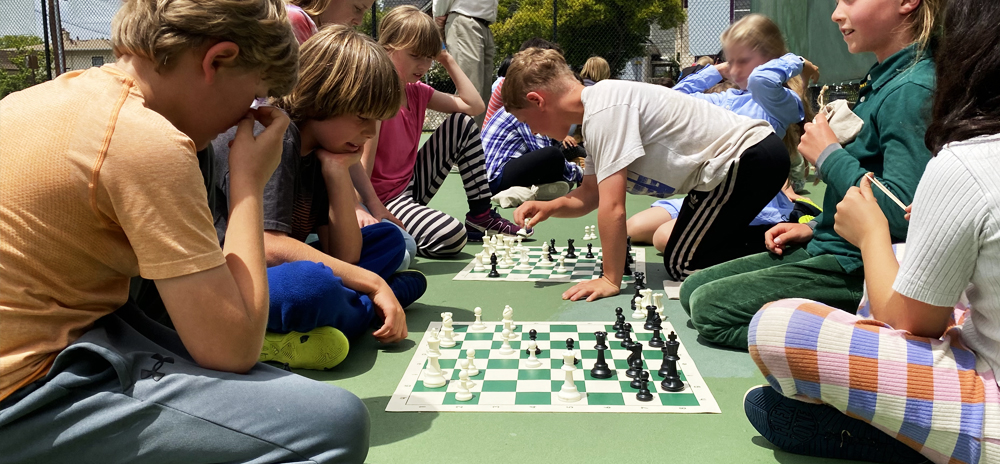 Grades 3 & Grade 4 playing chess after playing soccer