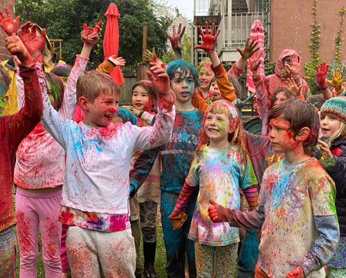Children covered in color after celebrating the Indian holiday Holi