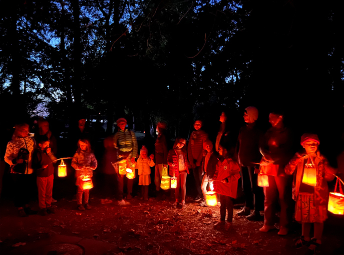 Berkeley Rose families gather at night to do a lantern lit walk through the forest