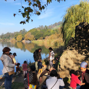 Teacher with parents & children play group at lake temescal
